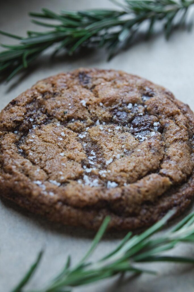 brown butter chocolate chip cookies with rosemary sprigs