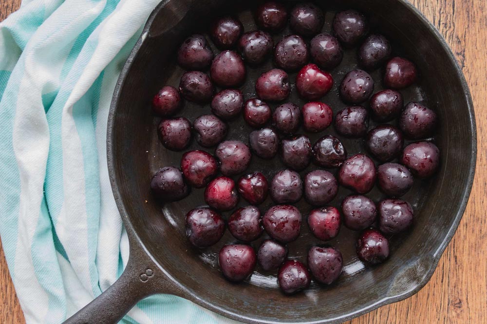 fresh summer cherries in a cast iron skillet