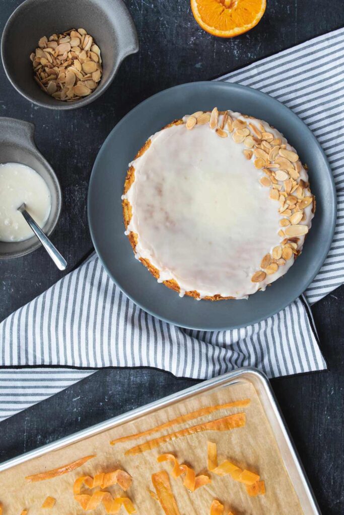 decorating the carrot cake with almond and candied carrots