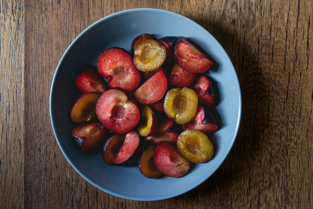 sliced plums in a bowl