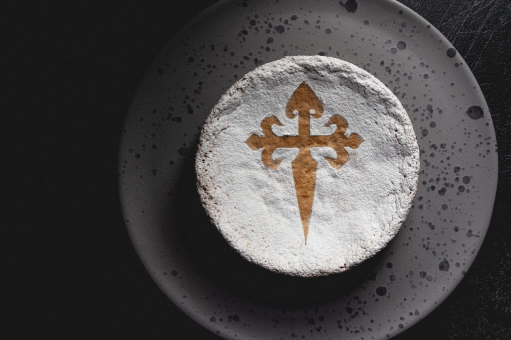 Tarta de santiago on a cake stand