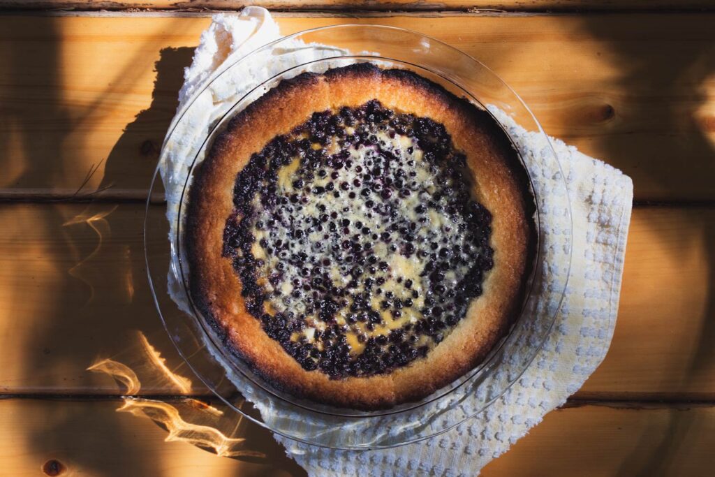 mustikkapiirakka blueberry tart on a wooden picnic table