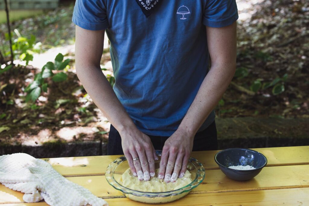 pressing shortcrust dough into a pie plate