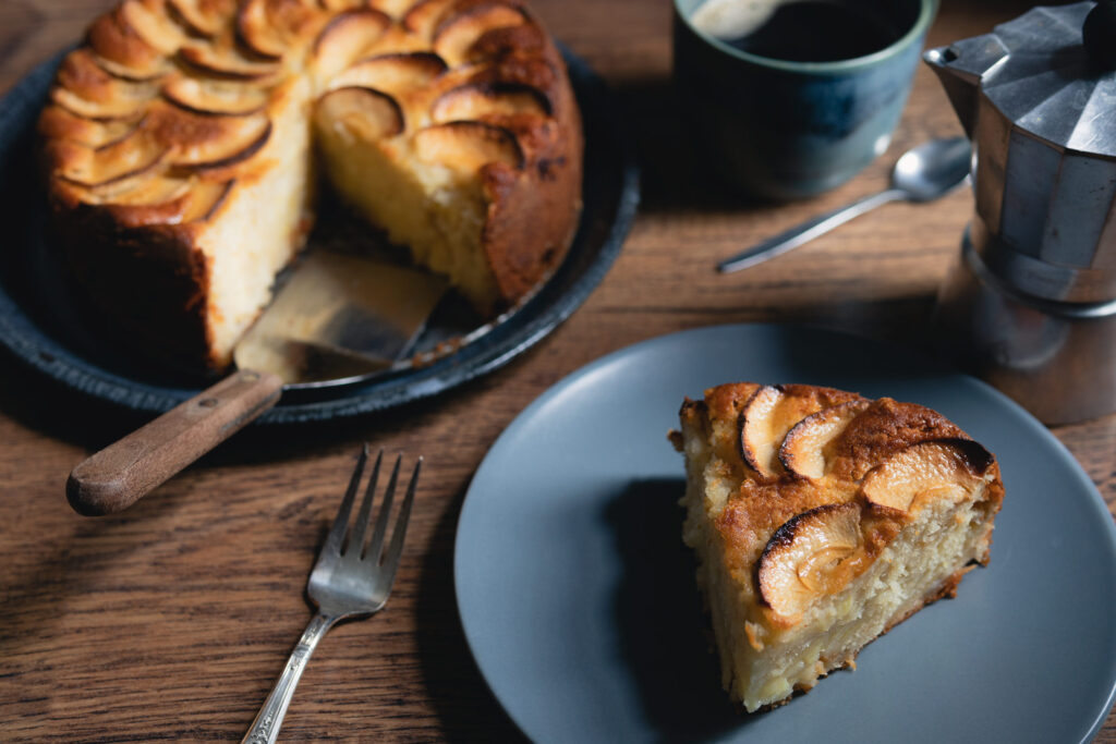 a slice of torta di mele with moka pot coffee