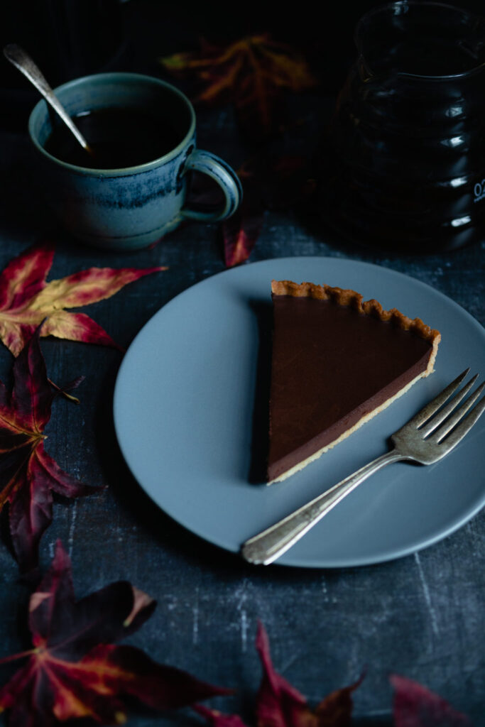a slice of tarte au chocolate and a cup of coffee