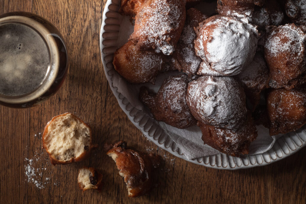 glass of dark beer and oliebollen