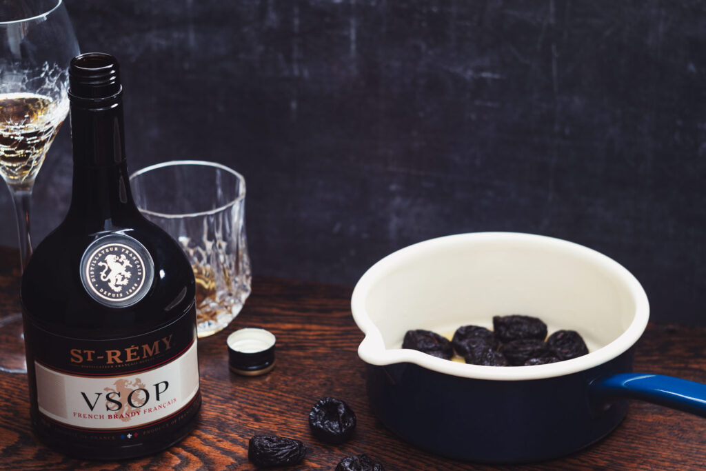 bottle of brandy and a pan of prunes