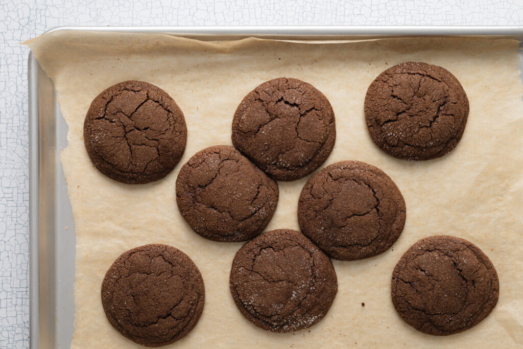 chocolate buckwheat cookies on a parchment paper lined baking sheet