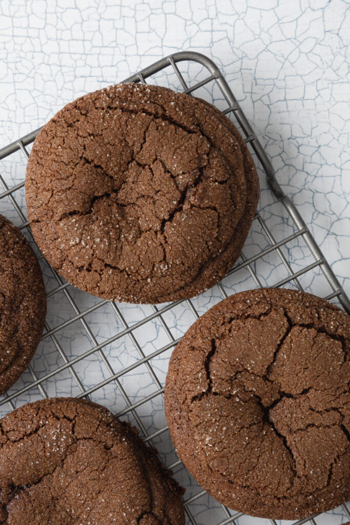 chocolate buckwheat cookies on a wire cooling rack on a white background
