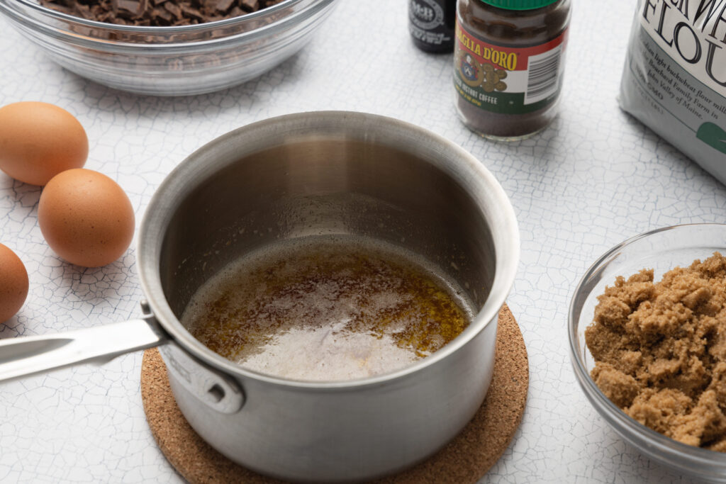 brown butter in a pan on a table with baking ingredients