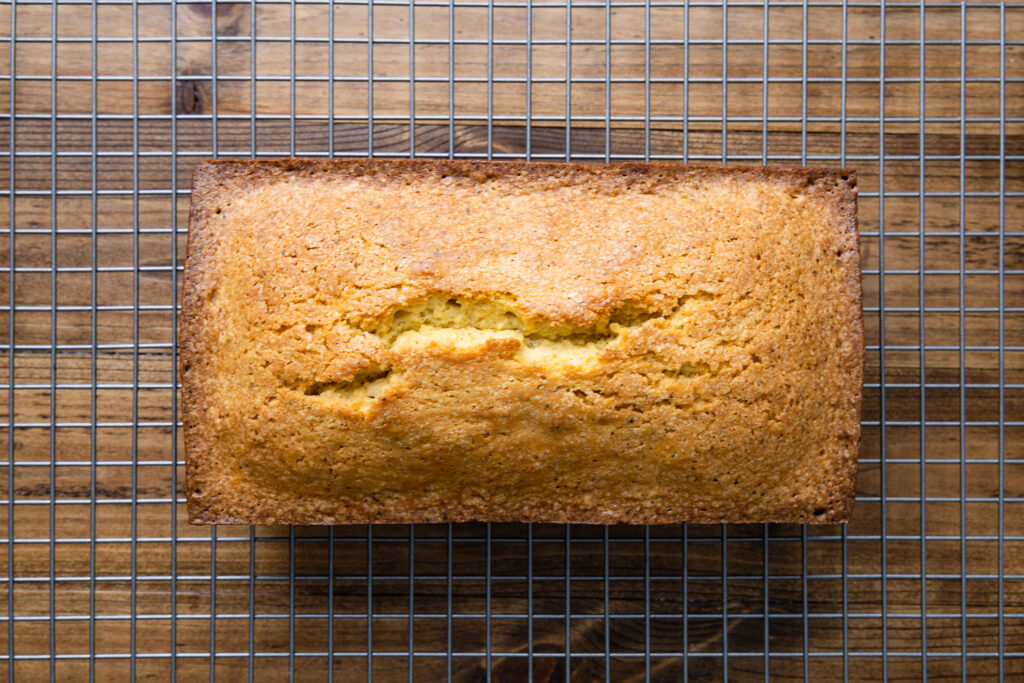 the baked pound cake cooling on a wire rack